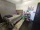 Bedroom with dark wood floors, neutral walls, a bed, and shelves filled with toys at 5419 Brass Hills Ct, Las Vegas, NV 89122
