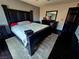 A cozy bedroom featuring a large bed, dark wood furnishings, and neutral decor at 5419 Brass Hills Ct, Las Vegas, NV 89122