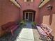 Charming front courtyard with decorative benches, gravel, and lush greenery at 5419 Brass Hills Ct, Las Vegas, NV 89122