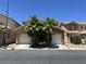 Charming two-story home featuring a two-car garage, palm trees, and a well-maintained front yard at 5419 Brass Hills Ct, Las Vegas, NV 89122
