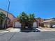 Inviting two-story home featuring a two-car garage and mature palm trees in a well maintained neighborhood at 5419 Brass Hills Ct, Las Vegas, NV 89122