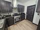 Modern kitchen with dark cabinets, stainless steel appliances, granite countertops, and stylish tile flooring at 5419 Brass Hills Ct, Las Vegas, NV 89122