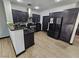 Modern kitchen with dark cabinets, stainless steel appliances, granite countertops, and stylish tile flooring at 5419 Brass Hills Ct, Las Vegas, NV 89122