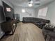 A beautifully staged living room featuring a large sectional, tile floors, and ample natural light at 5419 Brass Hills Ct, Las Vegas, NV 89122