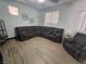 A beautifully staged living room featuring a large sectional, tile floors, and ample natural light at 5419 Brass Hills Ct, Las Vegas, NV 89122