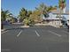 A well-maintained parking lot in front of a charming building with desert landscaping and palm trees under a clear blue sky at 5841 Medallion Dr # 102, Las Vegas, NV 89122