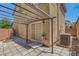 Enclosed backyard patio area with custom pavers, iron pergola and mature trees at 589 Brinkburn Point Ave, Las Vegas, NV 89178