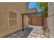 Enclosed backyard patio area with custom pavers, iron pergola, block wall for privacy at 589 Brinkburn Point Ave, Las Vegas, NV 89178