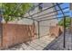 Enclosed backyard patio area with custom pavers, iron pergola, block wall and privacy at 589 Brinkburn Point Ave, Las Vegas, NV 89178