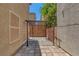 Enclosed backyard patio area with custom pavers, iron pergola, block wall for privacy at 589 Brinkburn Point Ave, Las Vegas, NV 89178