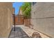 Enclosed backyard patio area with custom pavers, iron pergola, block wall and privacy at 589 Brinkburn Point Ave, Las Vegas, NV 89178