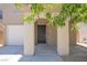 Covered front porch with decorative columns, white garage door, and stone landscaping at 589 Brinkburn Point Ave, Las Vegas, NV 89178