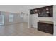 An open-plan kitchen featuring dark cabinetry and flowing into the living area at 589 Brinkburn Point Ave, Las Vegas, NV 89178