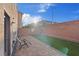 Backyard features include lounge chairs, synthetic grass, and a brick border at 6056 Atlantis Dream Ave, Las Vegas, NV 89139