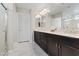 Elegant bathroom featuring a double vanity, granite countertops, and a glass-enclosed shower at 6056 Atlantis Dream Ave, Las Vegas, NV 89139