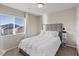 Cozy bedroom showcasing a comfortable bed with white bedding and a window view at 6056 Atlantis Dream Ave, Las Vegas, NV 89139