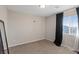 Unfurnished bedroom with neutral walls, large window with black out curtains, and plush carpeting at 6056 Atlantis Dream Ave, Las Vegas, NV 89139