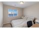 Cozy bedroom featuring a comfortable bed, window with blinds, and a calming atmosphere at 6056 Atlantis Dream Ave, Las Vegas, NV 89139