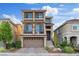 Charming three-story home showcasing a private balcony, low-maintenance landscaping, and a two-car garage at 6056 Atlantis Dream Ave, Las Vegas, NV 89139