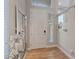 Bright foyer featuring wood-look floors, neutral paint, a sizable mirror, and a window allowing natural light at 6056 Atlantis Dream Ave, Las Vegas, NV 89139
