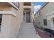 Inviting front entrance features a long stairway, modern hardware, and well-maintained exteriors at 6056 Atlantis Dream Ave, Las Vegas, NV 89139