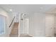Bright hallway featuring wood stairs, neutral walls, and natural light from a window at 6056 Atlantis Dream Ave, Las Vegas, NV 89139