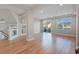 Open living area with hardwood floors, modern finishes, and sliding glass doors to a balcony at 6056 Atlantis Dream Ave, Las Vegas, NV 89139