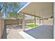 A covered patio enhances this backyard with gravel and artificial turf, a great outdoor living space at 6133 Roseboro Ct, North Las Vegas, NV 89081