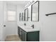 Stylish bathroom with a double vanity, modern lighting fixtures, and a clean, contemporary design at 6133 Roseboro Ct, North Las Vegas, NV 89081