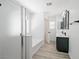 Modern bathroom with a glass-enclosed shower, tub, double vanity, and sleek fixtures at 6133 Roseboro Ct, North Las Vegas, NV 89081