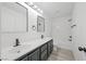Bathroom with dual sinks, dark cabinets, and a shower/tub combination at 6133 Roseboro Ct, North Las Vegas, NV 89081