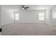 Large primary bedroom featuring neutral carpet, natural light, and an en suite bathroom at 6133 Roseboro Ct, North Las Vegas, NV 89081
