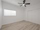 Bedroom features wood-look floors, neutral walls, a window and double door closet at 6133 Roseboro Ct, North Las Vegas, NV 89081