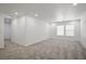 Bright, open bedroom with plush carpeting and natural light from a window at 6133 Roseboro Ct, North Las Vegas, NV 89081