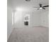 Spacious bonus room featuring plush carpeting, modern ceiling fan, and easy access to the en suite bathroom at 6133 Roseboro Ct, North Las Vegas, NV 89081