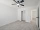 Bedroom featuring carpeted floors, ceiling fan, and an open closet at 6133 Roseboro Ct, North Las Vegas, NV 89081
