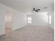 Spacious bonus room with a ceiling fan, neutral carpeting, and lots of natural light at 6133 Roseboro Ct, North Las Vegas, NV 89081