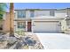 Charming two-story home with a well-manicured front yard, two car garage, and desert landscaping at 6133 Roseboro Ct, North Las Vegas, NV 89081