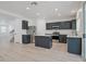 Bright kitchen with stainless steel appliances, island, white countertops, and modern finishes at 6133 Roseboro Ct, North Las Vegas, NV 89081