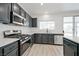Modern kitchen featuring stainless steel appliances, sleek countertops, and ample cabinet space at 6133 Roseboro Ct, North Las Vegas, NV 89081