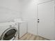 Laundry room featuring a washer, dryer, and storage racks at 6133 Roseboro Ct, North Las Vegas, NV 89081