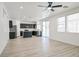 Open-concept living space with sleek plank flooring flowing into the kitchen, offering modern appeal at 6133 Roseboro Ct, North Las Vegas, NV 89081
