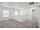 Well-lit loft area with gray carpeting, white walls and trim, offering an open and inviting space at 6133 Roseboro Ct, North Las Vegas, NV 89081