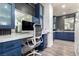 Contemporary bathroom with custom blue cabinetry, a spacious countertop, and a well-lit vanity area with modern fixtures at 6351 Abacus Farms Ct, Las Vegas, NV 89131