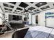 Modern bedroom with a coffered ceiling, media center, and access to a small kitchenette and a private retreat at 6351 Abacus Farms Ct, Las Vegas, NV 89131