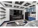 Stylish bedroom with a decorative coffered ceiling, media center, fireplace, and kitchenette with blue cabinetry at 6351 Abacus Farms Ct, Las Vegas, NV 89131