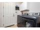 Laundry room with white cabinets, shelving and modern appliances at 6351 Abacus Farms Ct, Las Vegas, NV 89131