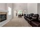 Open concept living room with a fireplace, high ceilings, neutral color palette, and an adjacent dining area at 6351 Abacus Farms Ct, Las Vegas, NV 89131