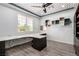 Bright home office featuring a custom built-in desk, unique ceiling detail, and wood-look flooring at 6351 Abacus Farms Ct, Las Vegas, NV 89131