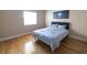 Bedroom with light hardwood floors, a queen bed, and a window with blinds at 6493 Yellow Bells Ct, Las Vegas, NV 89131